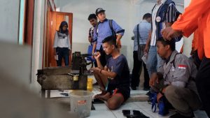 pengajin sedang memotong bahan untuk kaleng